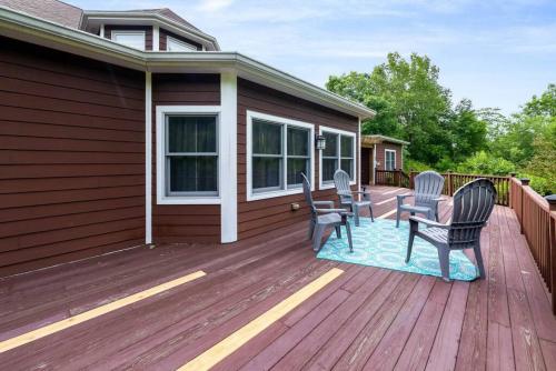 a deck with chairs and a table on a house at 5755 Butler Warren Cheerful 6-Bedroom Villa with fishing pond in Jericho