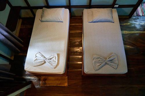 two white mats with bows on them sitting on the floor at Luz En El Cielo Eco-B&B/Hostel in Montezuma