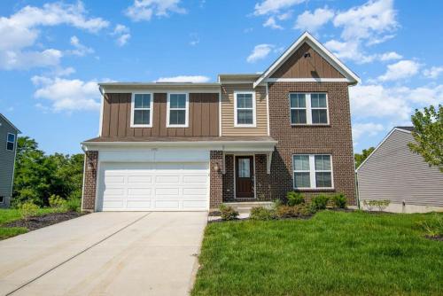a large brick house with a white garage at 1392 Soaring Way Brand new construction in well-kept HOA community in Maineville