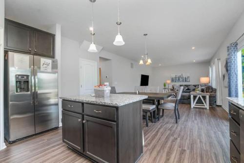 a kitchen and dining room with a stainless steel refrigerator at 1392 Soaring Way Brand new construction in well-kept HOA community in Maineville
