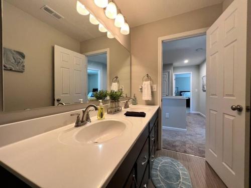 A bathroom at 7876 Ellington Court Cheerful 4 Bedroom Home Brand New Construction