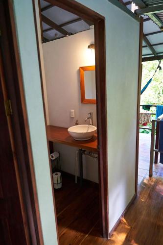a bathroom with a sink and a mirror at Luz En El Cielo Eco-B&B/Hostel in Montezuma