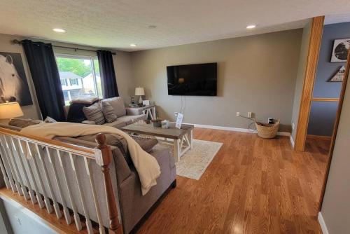 a living room with a couch and a tv at 1349 Jennings court Private Pool, Fire pit, BBQ A FUN place to RELAX in Mason