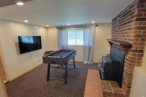 a room with a ping pong table in front of a fireplace at 1349 Jennings court Private Pool, Fire pit, BBQ A FUN place to RELAX in Mason