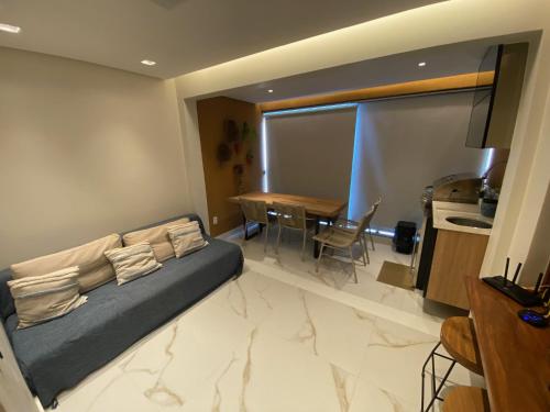 a bedroom with a bed and a dining room with a table at FLAT PRAIA DOS CARNEIROS - Eco Resort Praia dos Carneiros ao lado da Igrejinha in Rio Formoso