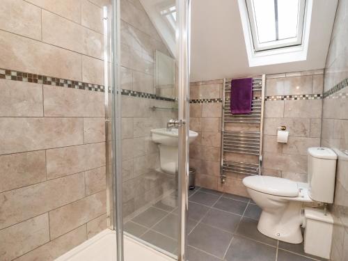 a bathroom with a toilet and a shower at The Stables in Chipping Norton