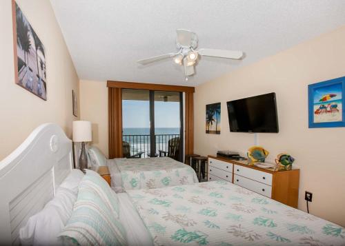 a bedroom with two beds and a flat screen tv at Phoenix II 2067 in Orange Beach