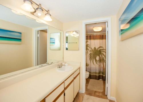 a bathroom with a sink and a mirror at Phoenix II 2067 in Orange Beach