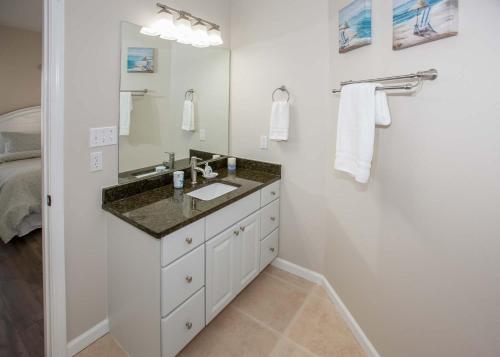 a bathroom with a sink and a mirror at Poseidon Palace in Sand Landing