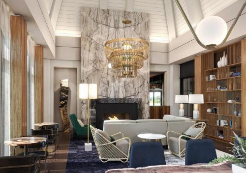 a lobby with a couch and chairs and a fireplace at Hotel Hartness in Greenville