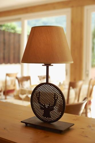 a lamp sitting on top of a table at Hotel Weiss in Rablà