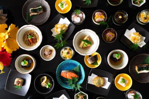 a group of plates of food on a table at Kyoto Yamashina Hotel Sanraku in Kyoto