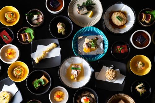 a bunch of plates of food on a table at Kyoto Yamashina Hotel Sanraku in Kyoto
