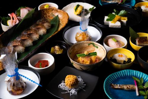 a table topped with lots of different types of food at Kyoto Yamashina Hotel Sanraku in Kyoto