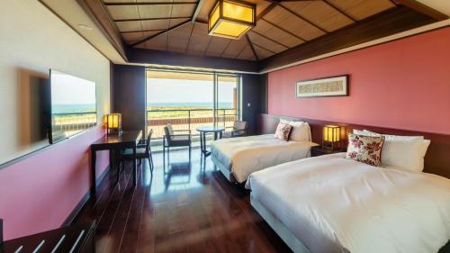 a hotel room with two beds and a table and chairs at Miyakojima Kurima Resort Seawood Hotel in Miyako Island