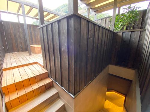 a staircase in a house with a wooden wall at Hotel Zagakukan in Hakone
