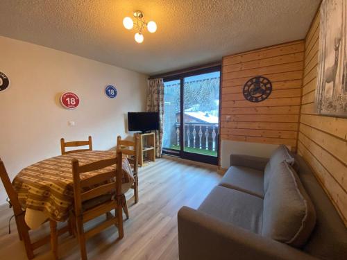 un salon avec un canapé et une table dans l'établissement Appartement lumineux proche des pistes du Linga avec Multi Pass été à 3€/jour! - FR-1-693-21, à Châtel