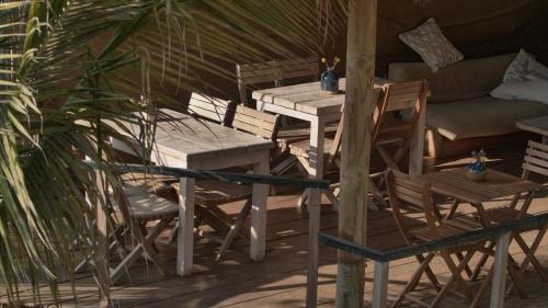 a patio with a table and chairs and a couch at Amai Luna in Máncora