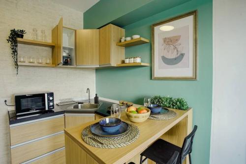 a kitchen with a table with bowls of fruit on it at Vicar Home by Serin East Tagaytay in Tagaytay