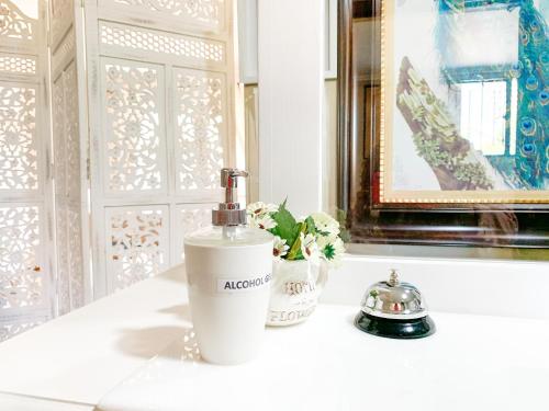 a white bottle of soap sitting on top of a counter at Hostal Pehuenche in Talca