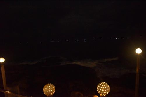 two street lights at night with the ocean in the background at New Ocean Hill Hotel in Hikkaduwa