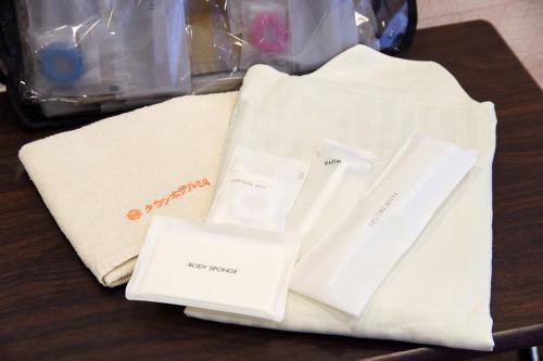 a table with two white towels on a table at Otsuka Town Hotel in Tokyo