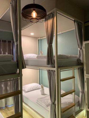 a room with four bunk beds in it at Busket Hostel in Chiang Rai