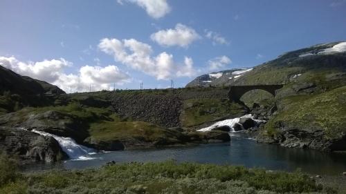 a river with two waterfalls in a mountain at Vatnahalsen Høyfjellshotell in Myrdal
