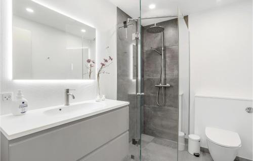 a white bathroom with a sink and a shower at 1 Bedroom Awesome Apartment In Allinge in Sandvig