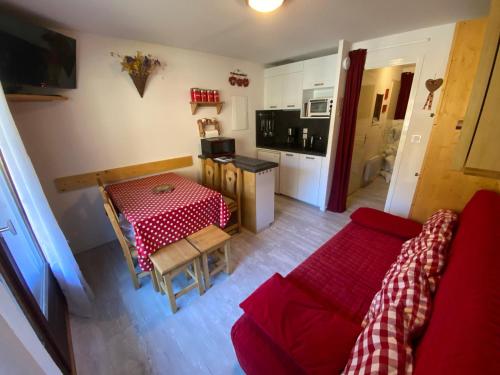 un salon avec un canapé rouge et une table dans l'établissement Bel appartement à Châtel près du centre et des télécabines, avec Multi Pass été à 3€/jour/personne - FR-1-693-63, à Châtel