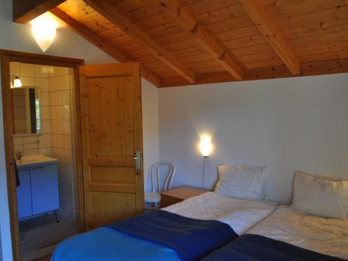 sypialnia z dwoma łóżkami i drewnianym sufitem w obiekcie Chalet 12 pers avec 6 chambres à La Chapelle-d'Abondance - FR-1-692-2 w mieście La Chapelle-dʼAbondance