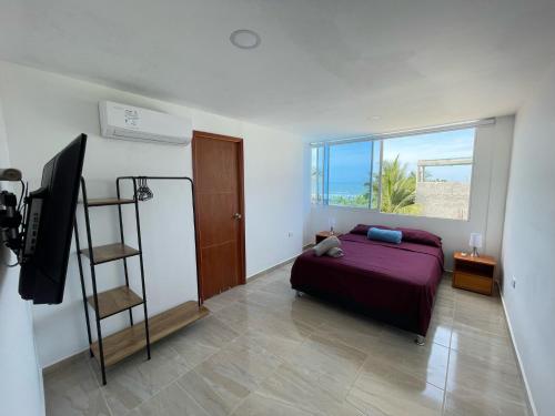a bedroom with a bed and a view of the ocean at Hotel La Yarolina SAS in Cartagena de Indias