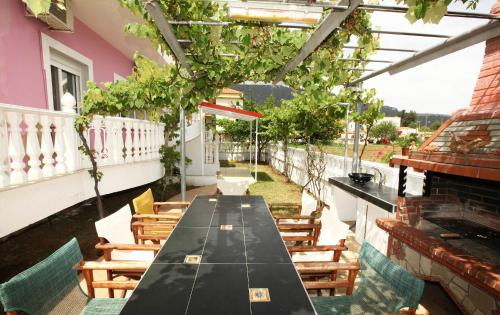 a long black table and chairs on a patio at Nereids Apartments and Studios in Chrysi Ammoudia