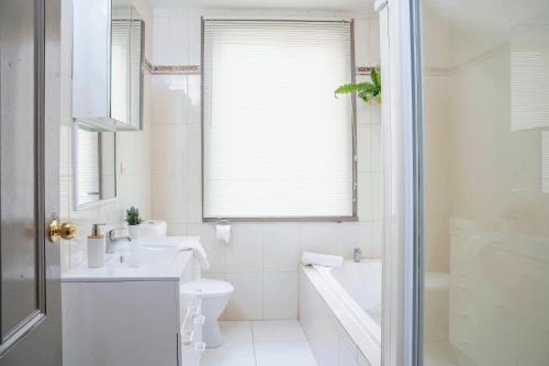 a white bathroom with a sink and a toilet at #Grampians Views Getaway #CBD #Netflix in Stawell
