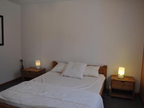 - une chambre avec un lit et 2 lampes sur les tables dans l'établissement Charmant appartement avec grande terrasse exposée plein sud et garage! - FR-1-692-26, à La Chapelle-dʼAbondance