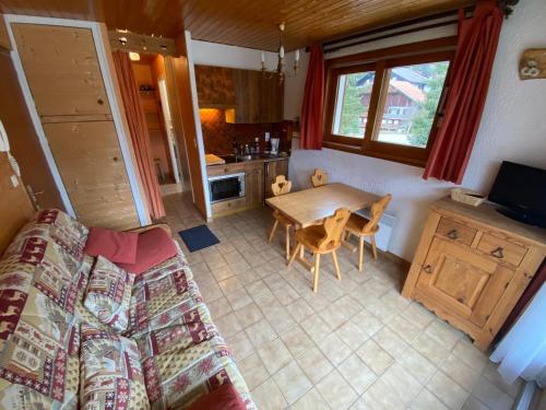 a living room with a couch and a table at Studio cosy proche pistes, parking, 4 pers - FR-1-692-54 in La Chapelle-dʼAbondance