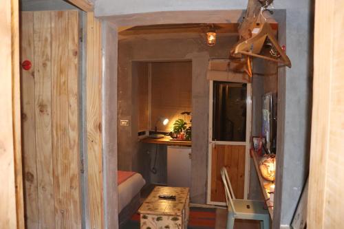 a small room with a bed and a table at Bunkyard in Udaipur