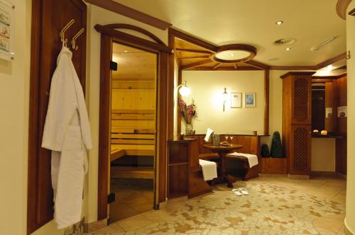 a bathroom with a door open to a room at Hotel Gasthof Perauer in Mayrhofen