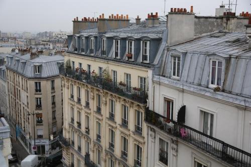 a group of buildings with balconies on top of them at Hotel Boronali - Nouvellement rénové in Paris