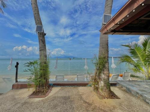 a view of the beach from the porch of a resort at The Shore Samui in Bang Rak Beach