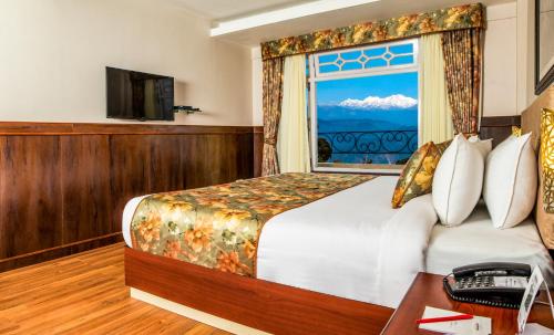 um quarto de hotel com uma cama e uma janela em Summit Oakden Resort & Spa em Darjeeling