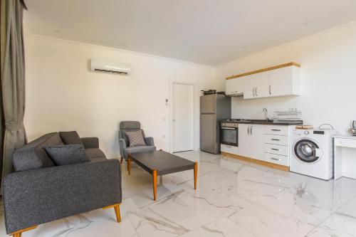 a living room with a couch and a kitchen at Nur Suites & Hotels in Kalkan