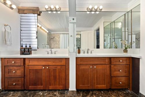 a bathroom with two sinks and a large mirror at Expansive Lanai w/ Panoramic Views - Walk to Waikiki Beach in Honolulu