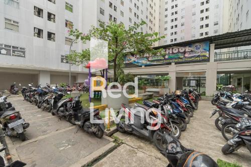 a row of motorcycles parked in front of a building at RedLiving Apartemen Kalibata City - SAG Property Tower Kemuning in Jakarta