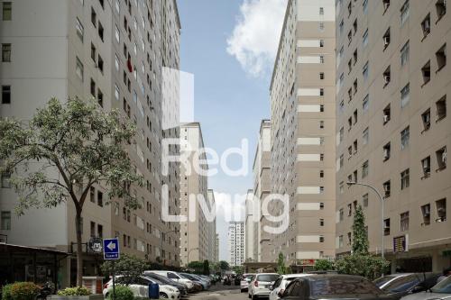 a city street with cars parked in front of tall buildings at RedLiving Apartemen Kalibata City - SAG Property Tower Kemuning in Jakarta
