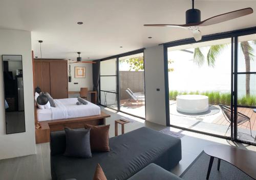 a living room with a bed and a couch at Villa Mandi in Ban Thong Phlu