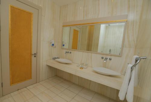 a bathroom with two sinks and a mirror at Gabala Garden Hotel in Gabala
