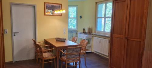 a dining room with a wooden table and chairs at Nationalparkresidenz in Lindberg