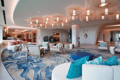 a waiting room with white furniture and blue pillows at Crowne Plaza Resort Guam in Tumon