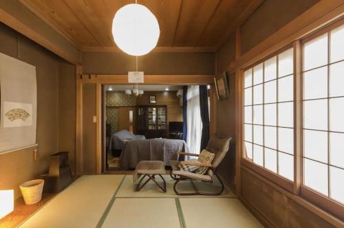 a room with a table and a chair and a window at Jokan-en in Honjo